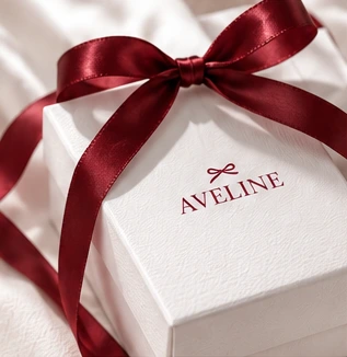 Aveline white gift packaging with a burgundy bow
